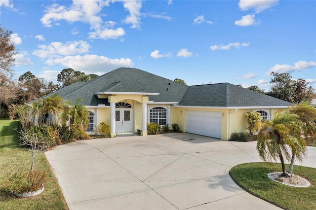 view of front facade with a garage and a front lawn