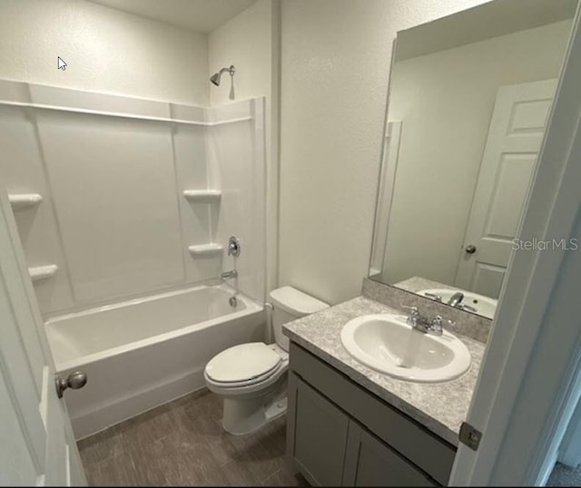 full bathroom with hardwood / wood-style flooring, vanity, toilet, and shower / washtub combination