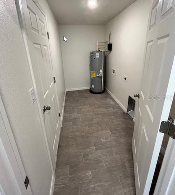 utility room with electric water heater