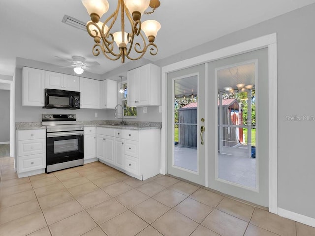 kitchen featuring stainless steel range with electric stovetop, ceiling fan with notable chandelier, sink, light tile patterned floors, and white cabinetry