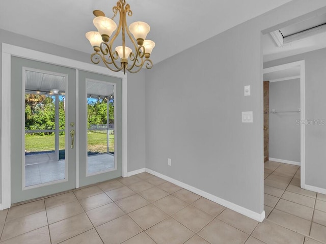 unfurnished dining area featuring light tile patterned floors and a chandelier