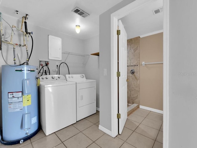 washroom with washer hookup, light tile patterned floors, and water heater