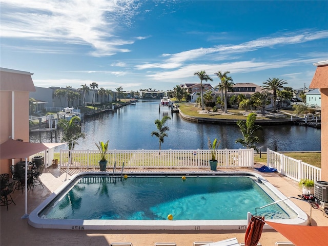 view of swimming pool with a patio, a water view, and central AC unit