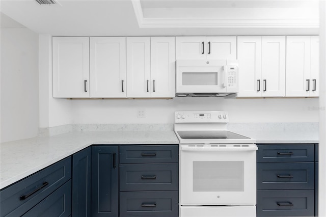 kitchen with white cabinetry, white appliances, and light stone countertops