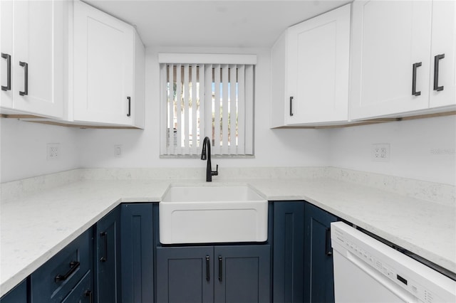 kitchen featuring blue cabinets, sink, white cabinetry, light stone counters, and dishwasher