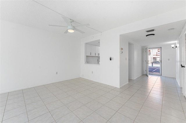 empty room featuring light tile patterned floors and ceiling fan