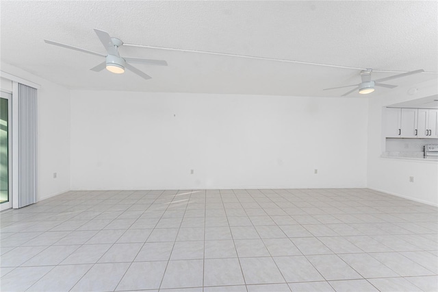 spare room featuring a textured ceiling and ceiling fan