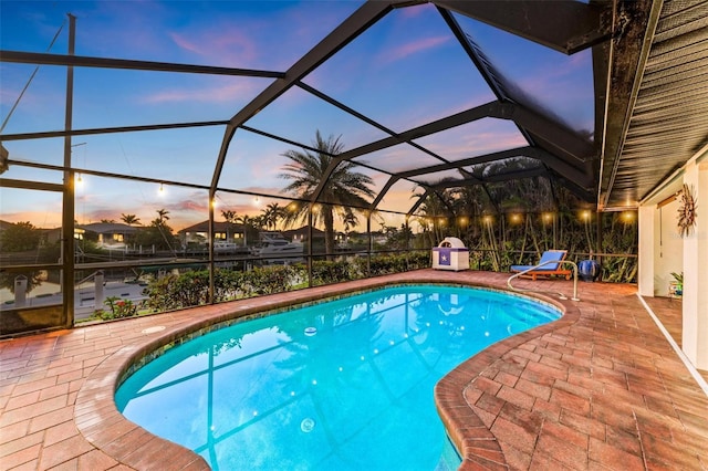 outdoor pool with a patio area and a lanai