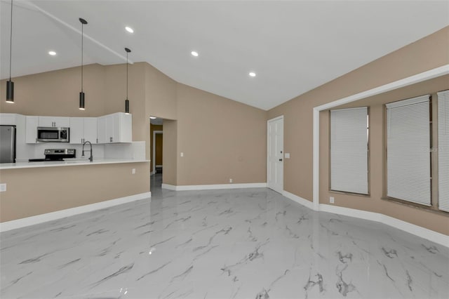 unfurnished living room featuring high vaulted ceiling