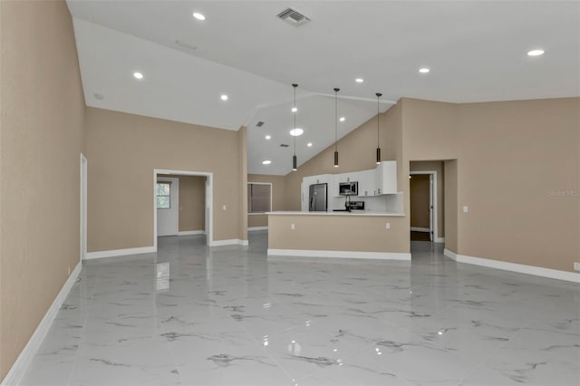 unfurnished living room featuring high vaulted ceiling