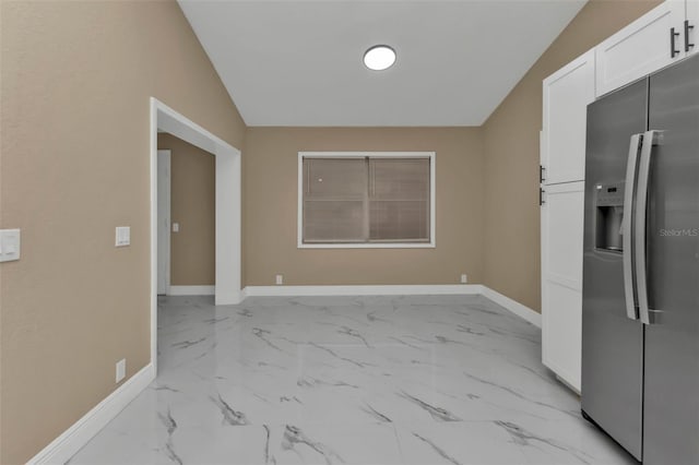 unfurnished dining area featuring lofted ceiling