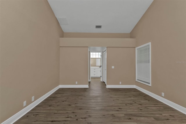 unfurnished room featuring dark wood-type flooring