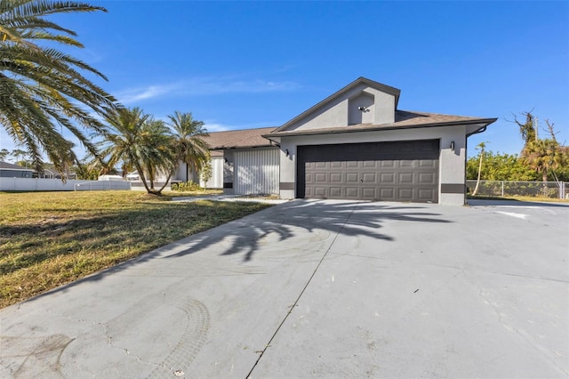 view of front facade with a front yard and a garage