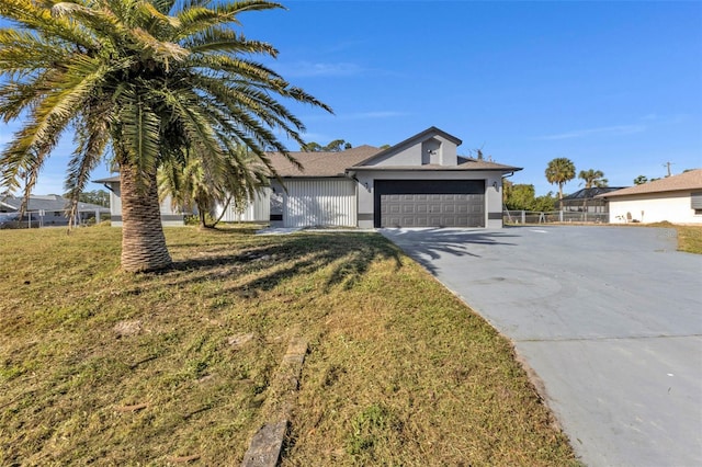 single story home with a garage and a front yard