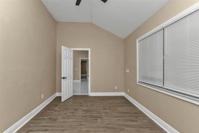 unfurnished bedroom with lofted ceiling, wood-type flooring, a closet, and ceiling fan