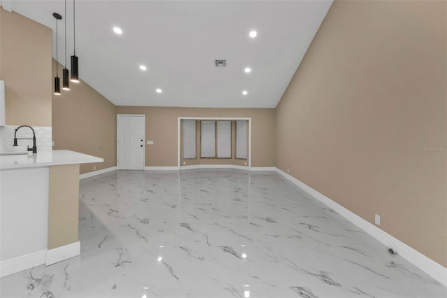 unfurnished living room featuring sink