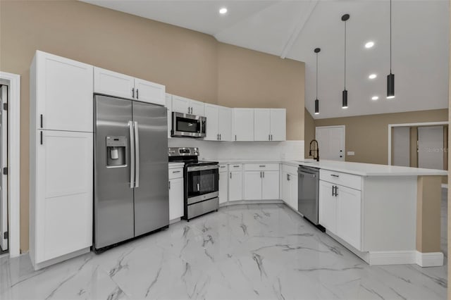 kitchen featuring appliances with stainless steel finishes, white cabinetry, decorative light fixtures, a high ceiling, and kitchen peninsula