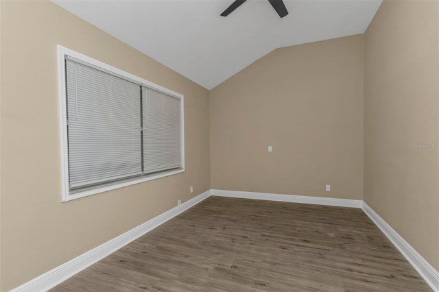 spare room with ceiling fan, wood-type flooring, and lofted ceiling