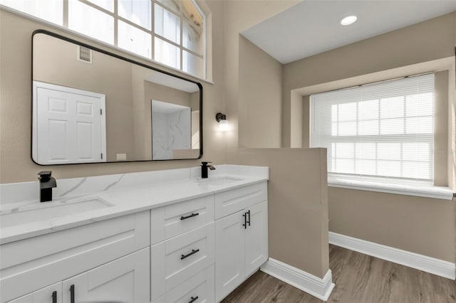 bathroom with hardwood / wood-style floors and vanity