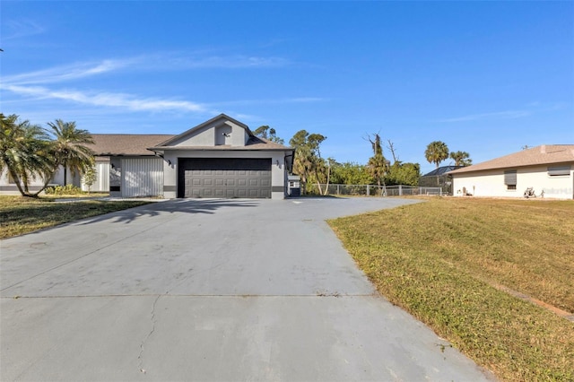 single story home featuring a garage and a front yard