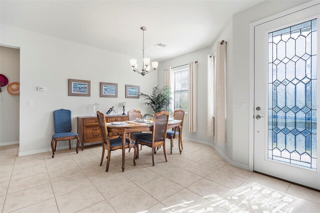 tiled dining area featuring a notable chandelier