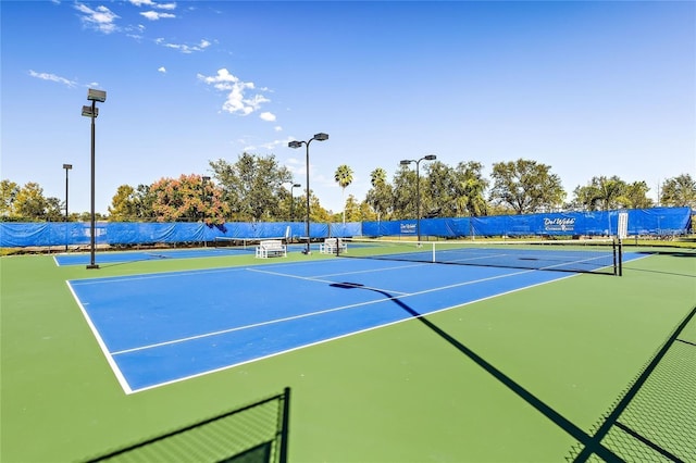 view of sport court featuring fence