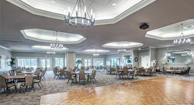 dining room featuring visible vents, ornamental molding, a tray ceiling, carpet, and a chandelier