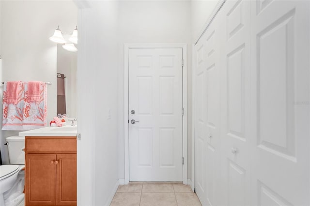 bathroom with vanity, tile patterned floors, toilet, and baseboards