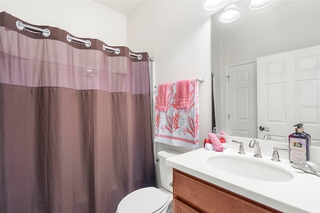 bathroom featuring vanity, curtained shower, and toilet