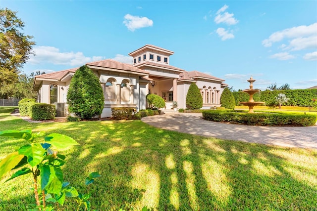 mediterranean / spanish home with a front yard