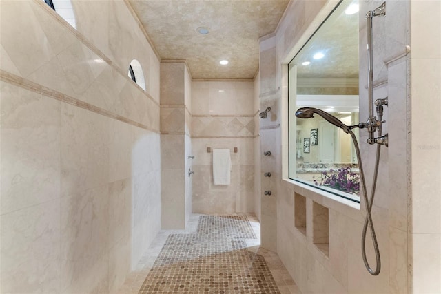 bathroom with tile patterned floors, a tile shower, and tile walls