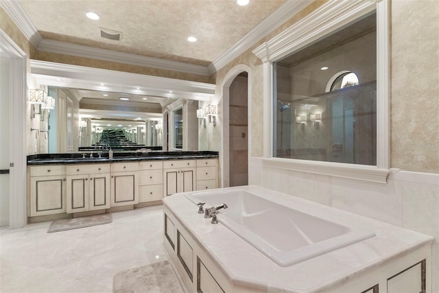 bathroom with vanity, crown molding, and a bath