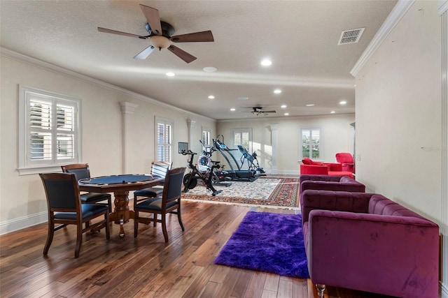 dining room featuring hardwood / wood-style floors, ceiling fan, and crown molding