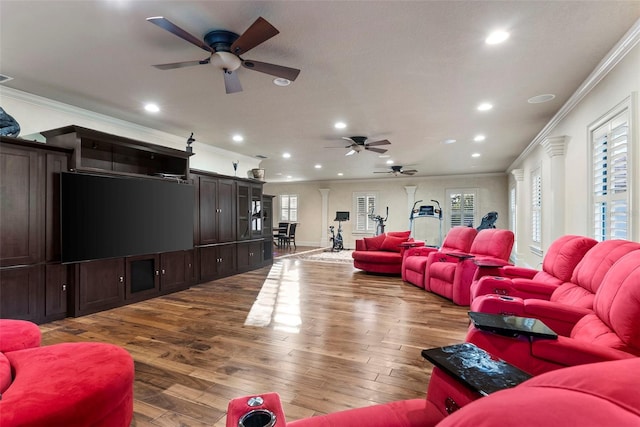 living room with ceiling fan, wood-type flooring, and ornamental molding