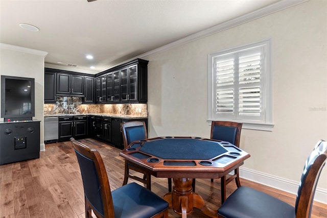 playroom featuring light hardwood / wood-style floors and crown molding