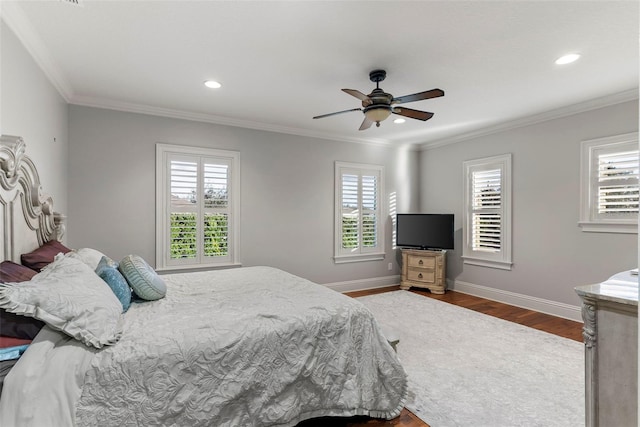 bedroom with ceiling fan, dark hardwood / wood-style flooring, crown molding, and multiple windows