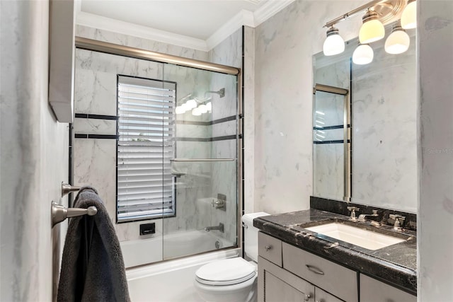 full bathroom with shower / bath combination with glass door, vanity, toilet, and ornamental molding