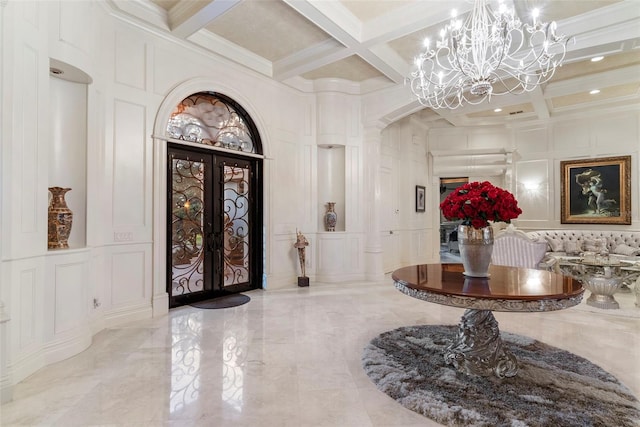 foyer entrance featuring coffered ceiling, an inviting chandelier, french doors, ornamental molding, and beam ceiling