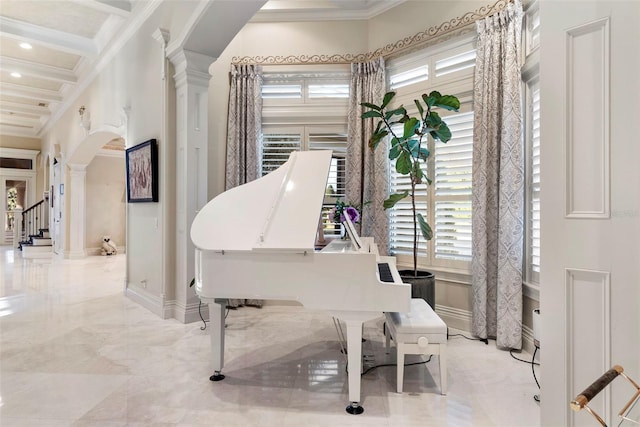 miscellaneous room with ornate columns, a high ceiling, coffered ceiling, beamed ceiling, and crown molding