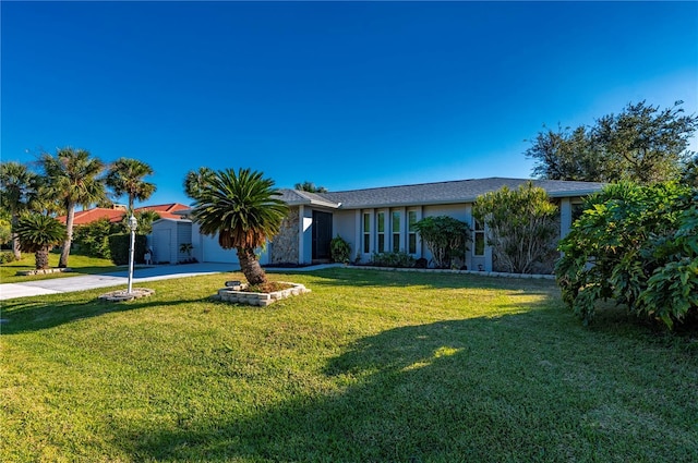 ranch-style home featuring a front lawn and a garage