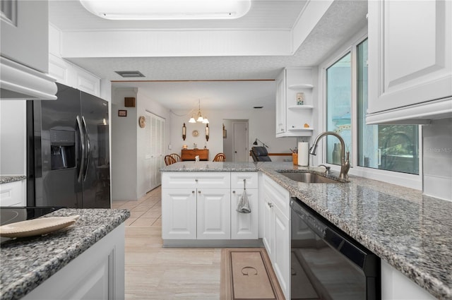 kitchen with kitchen peninsula, sink, black appliances, stone counters, and white cabinets