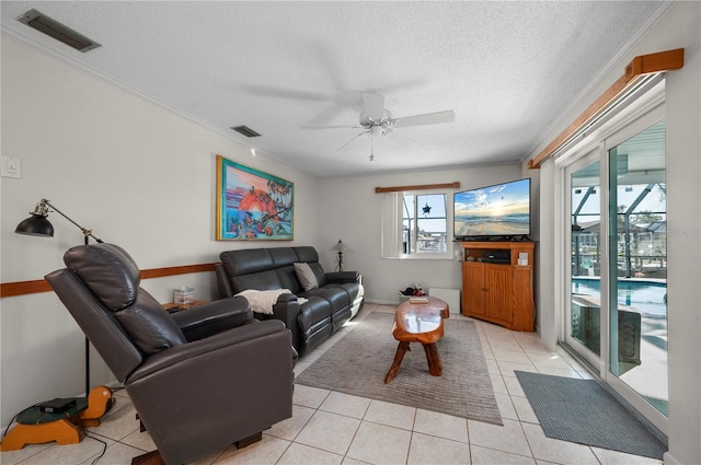 tiled living room featuring ceiling fan, crown molding, and a textured ceiling