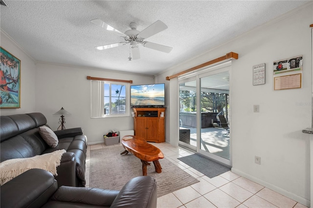 tiled living room featuring ceiling fan, crown molding, and a textured ceiling