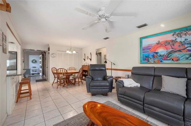 tiled living room featuring ceiling fan with notable chandelier, crown molding, and a textured ceiling