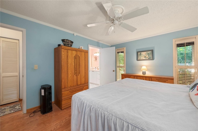 bedroom with ensuite bath, ceiling fan, light wood-type flooring, a textured ceiling, and ornamental molding