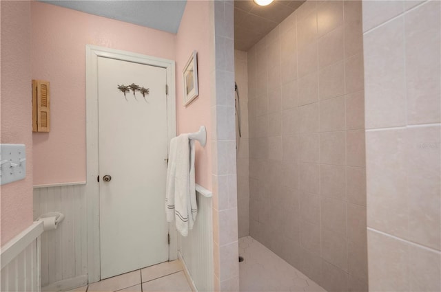 bathroom with a tile shower and tile patterned floors