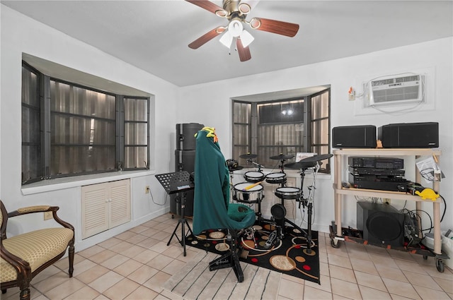 office area featuring an AC wall unit, ceiling fan, and light tile patterned flooring