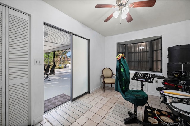 tiled office space featuring ceiling fan