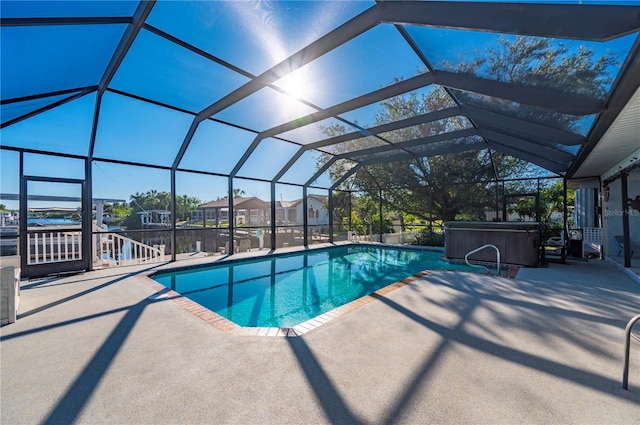 view of swimming pool with a lanai, a patio, and a hot tub