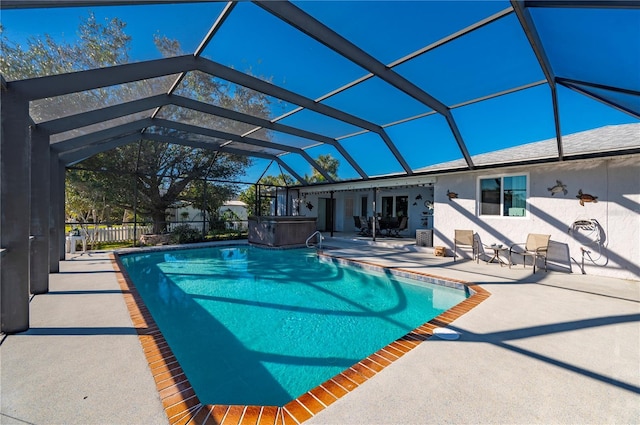 view of swimming pool featuring glass enclosure and a patio